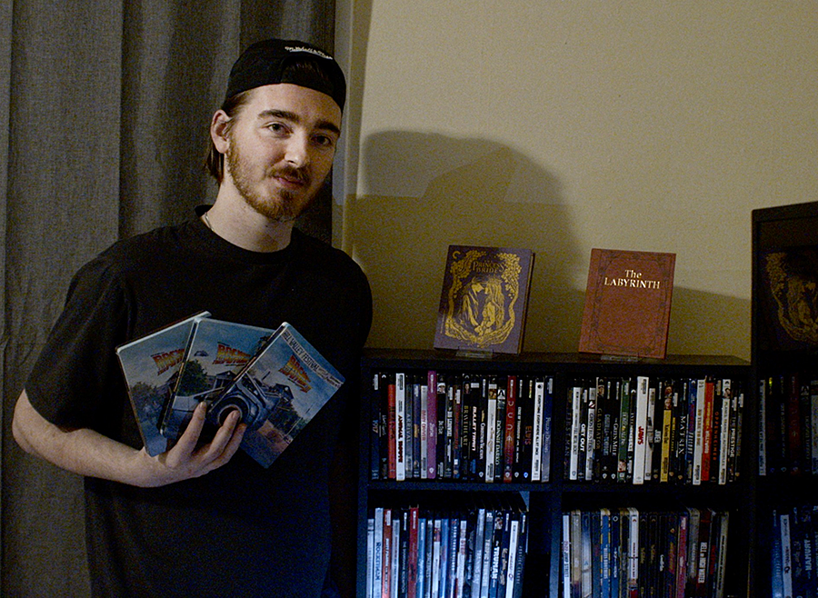  Jake Edwards holds the ‘Back to the Future’ trilogy alongside his movie collection in his bedroom on Oct. 16, 2024.